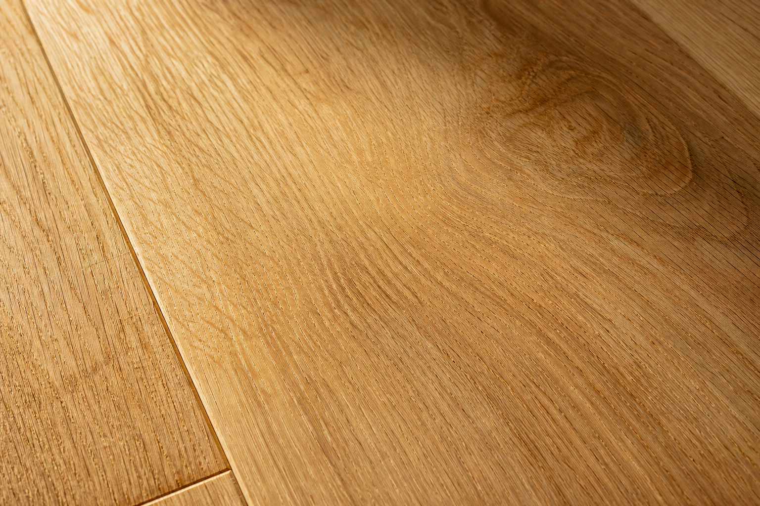 Close detail of white oak hardwood grain with a warm matte natural finish under window light